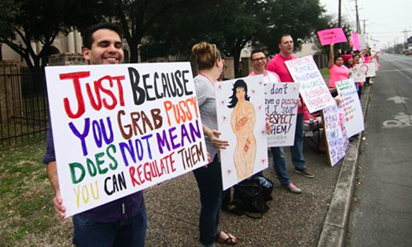 Planned Parenthood supporters hold signs at a 2017 San Antonio rally. - Michael Barajas