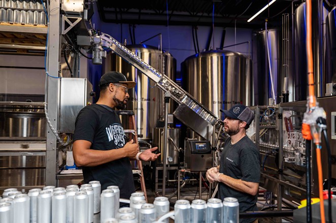 Baskerville speaks with a Weathered Souls employee at the Northeast San Antonio brewery. - Jaime Monzon