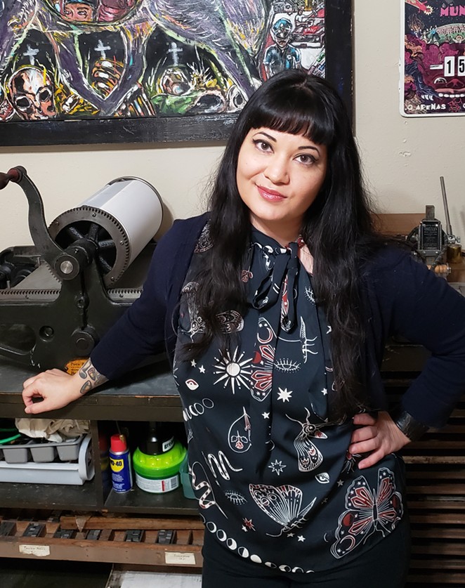 Keri Miki-Lani Schroeder with an early 20th-century Poco letterpress proof press in her San Antonio studio. - KERI MIKI-LANI SCHROEDER