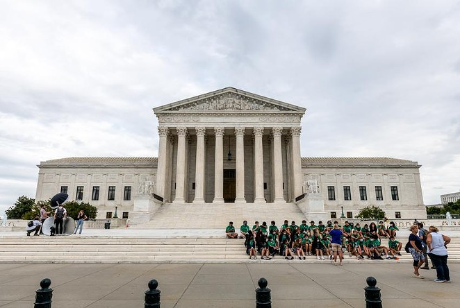 Children listen to a tour guide on the steps of the U.S. Supreme Court in Washington, D.C. - TEXAS TRIBUNE / ERIC LEE