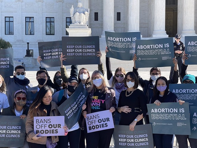 Abortion-rights advocates hold up signs in front of the U.S. Supreme Court last month. - TWITTER / AMYHM