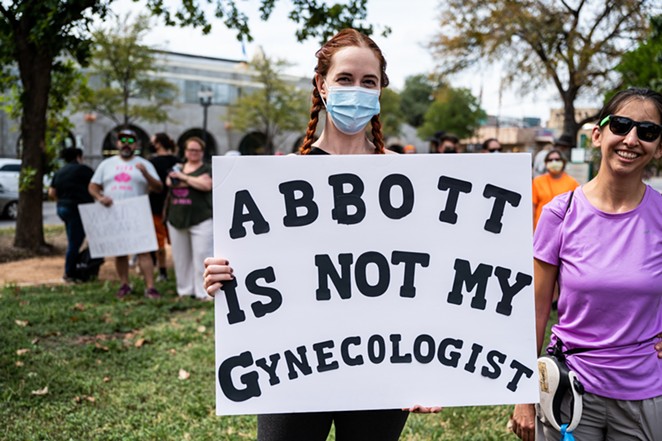 A protester at a San Antonio rally in defense of reproductive rights shows off her sign. - JAIME MONZON