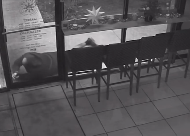 San Antonio’s Sari-Sari Filipino Restaurant, Market and Bakery posted this image of what appears to be a man lying on the sidewalk and trying to break the glass of its front door. - INSTAGRAM /  SARISARISATX