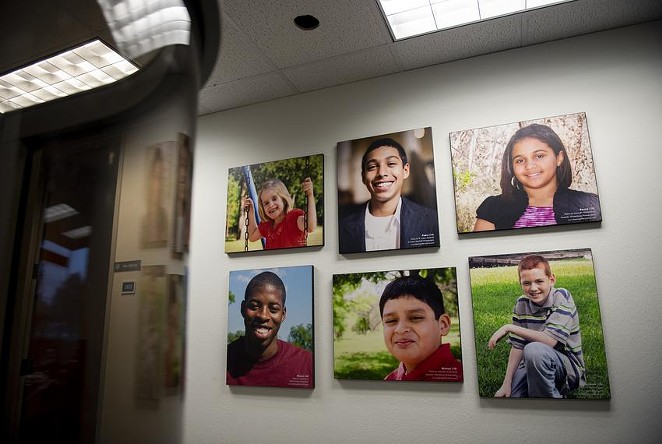 Portraits of adoptable children on display at the Child Protective Services office in Austin in 2019. - TEXAS TRIBUNE / EDDIE GASPAR