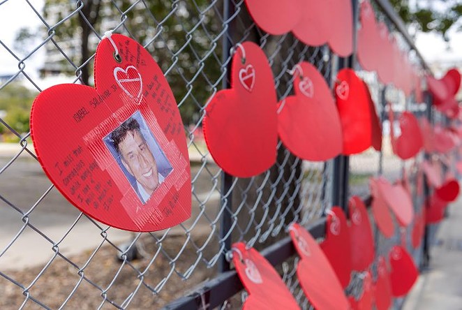 More than 3,400 red hearts were posted on a fence last year to honor San Antonio residents who have died from COVID-19 during the pandemic. - TEXAS TRIBUNE / CHRIS STOKES