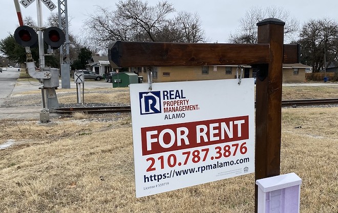 A sign stands in front of a rental property in a San Antonio neighborhood. - Sanford Nowlin