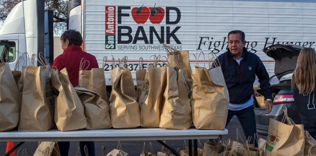Food Bank workers hand out consumables during a distribution event. - Courtesy Photo / San Antonio Food Bank