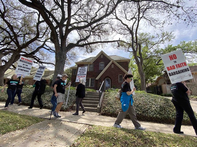 Musicians picket in front of the home of Kathleen Weir Vale, board chair for the Symphony Society. - Sanford Nowlin