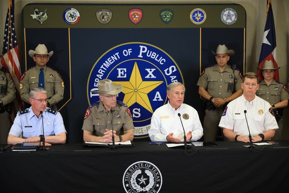 Gov. Greg Abbott surrounds himself with stern-looking men and women in uniform during one of his many recent immigration-related press conferences. - COURTESY PHOTO / OFFICE OF THE GOVERNOR