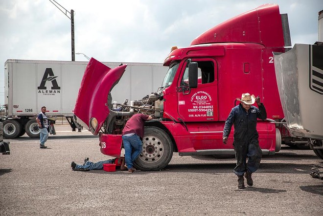 Mechanics fixed trucks last week at the inspection station near the Pharr International Bridge. - Texas / Tribune