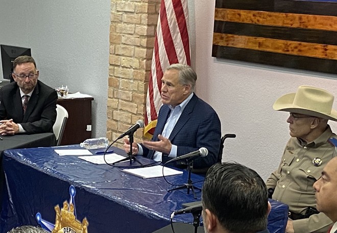 Gov. Greg Abbott plays up his law and order credentials during Thursday's press conference in San Antonio. - Sanford Nowlin
