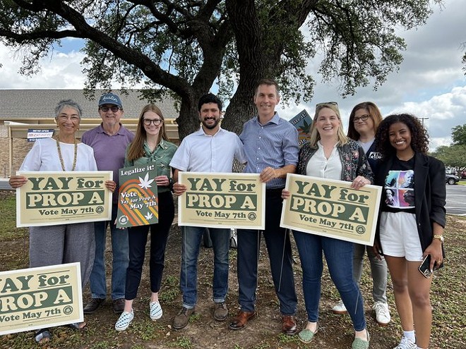 Prop A supporters including Democratic U.S. House candidate Greg Casar (fourth from left) pose with signs. - TWITTER / @JULIEOLIVERTX