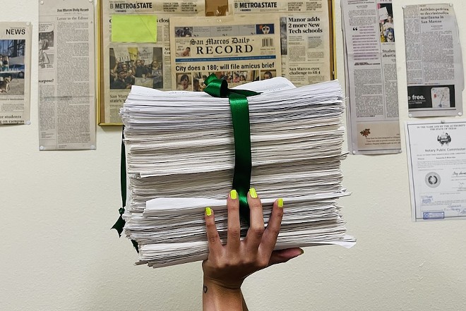 A cannabis reform advocate shows off petitions signed by San Marcos voters. - Courtesy Photo / Mano Amiga and Ground Game Texas