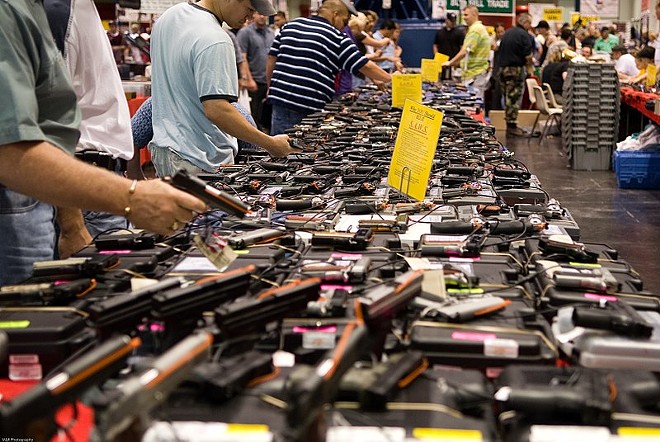 Browsers look at firearms at a Houston gun show. - WIKIMEDIA COMMONS / M&R GLASGOW