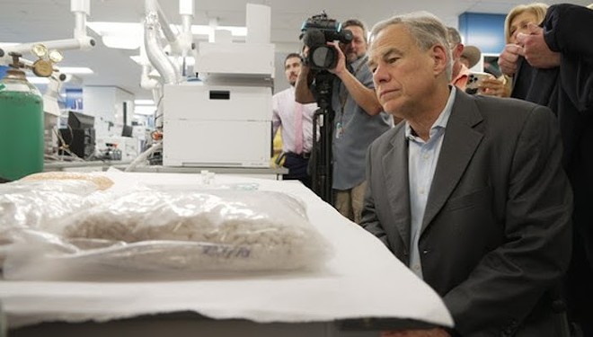 Gov. Greg Abbott looks at fentanyl while the cameras roll at his recent Houston press conference — and it sure looks deadly. - Office of the Governor