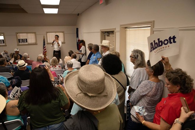 A Greg Abbott supporter holds up a sign at a town hall in Junction on Aug. 17. - Texas Tribune / Eddie Gaspar