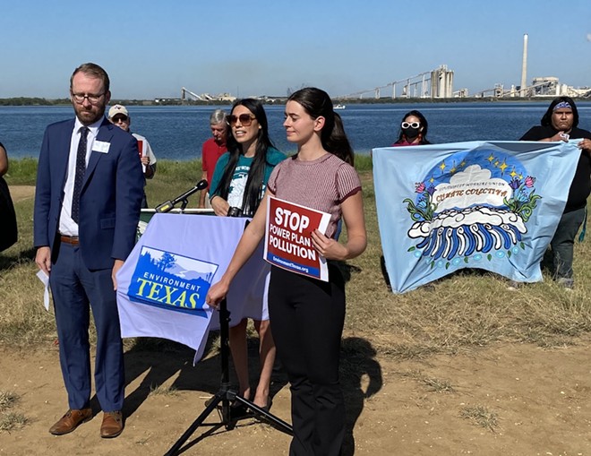 Environmental advocates speak at a press conference with CPS's Calaveras Power Station in the background. - Sanford Nowlin