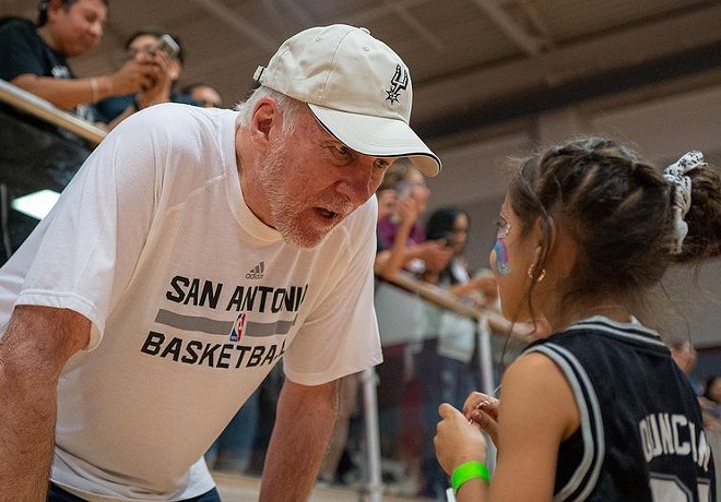 Coach Gregg Popovich interacts with a young fan during Saturday's practice in Uvalde. - Instagram / San Antonio Spurs