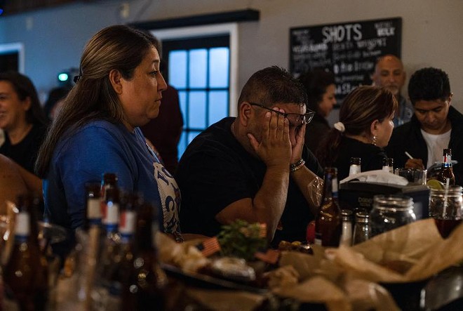 Jerry Mata, whose daughter Tess was one of the 19 students killed at Robb Elementary, rubs his eyes after learning the news that Gov. Greg Abbott was expected to win reelection during a watch party Tuesday at Lunkers Bar and Grill in Uvalde.