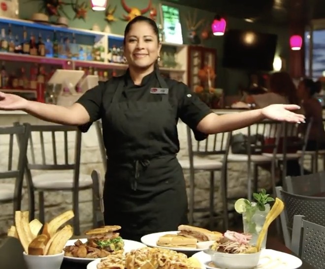 Luna Rosa Puerto Rican Grill y Tapas owner Iris Gonzalez-Ornelas shows off a section of menu items. - Instagram / livebrooks
