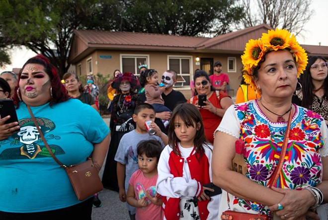 Attendees watch as the Día de los Muertos procession continues through the Alazán-Apache Courts in San Antonio on Nov. 1. - Texas Tribune / Azul Sordo