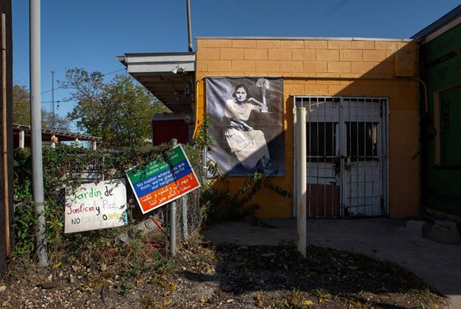 Photo banners stretch across the wall of the Rinconcito de Esperanza as part of a project started in 2006 depicting longtime residents of San Antonio’s West Side. - Texas Tribune / Azul Sordo
