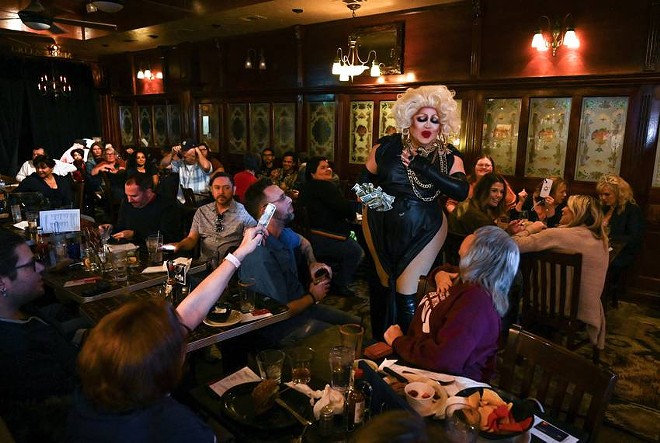 Daphne Rio, host of BuZz n’ BabeZz Drag Brunch, collects tips at the end the Jan. 14 show. - Texas Tribune / Leila Saidane