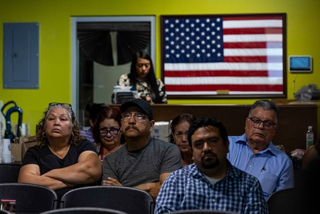 Attendees listen to speakers discuss new border wall contracts in nearby counties at the No Border Wall Coalition’s emergency border wall town hall in El Cenizo. - Texas Tribune / Michael Gonzalez