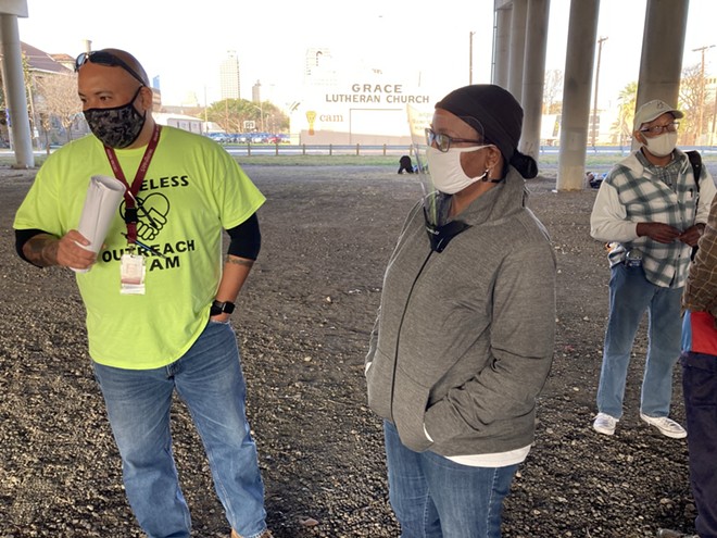 SAMMinistries staffers visit with unhoused people in an encampment beneath an overpass. - Courtesy / SAMMinistries