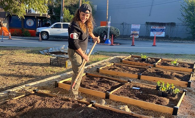 Jess Rivera helps build a garden in front of Little Death Wine Bar. - Facebook / LocalSprout Food Hub