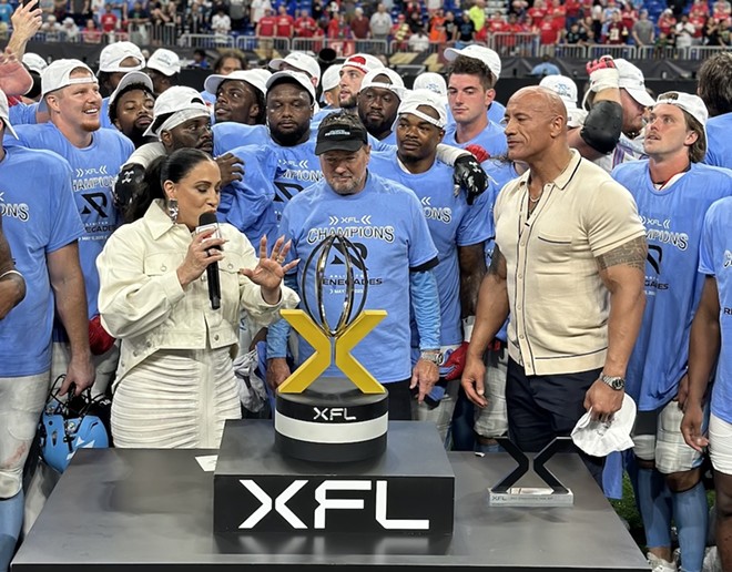 XFL League owners Dany Garcia (left) and Dwayne 'The Rock' Johnson (right) award the championship trophy to the Arlington Renegades at the Alamodome on May 13. - Michael Karlis