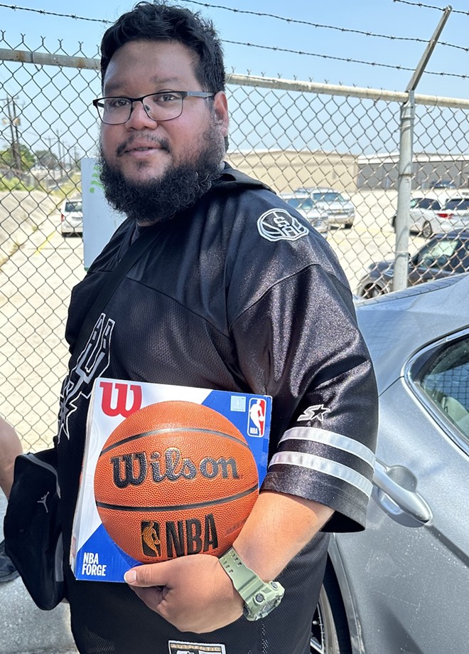 Lifelong Spurs fan Fred Carrasco arrived a the airpot around noon. He brought along a basketball for Wembanyama to sign. - Michael Karlis
