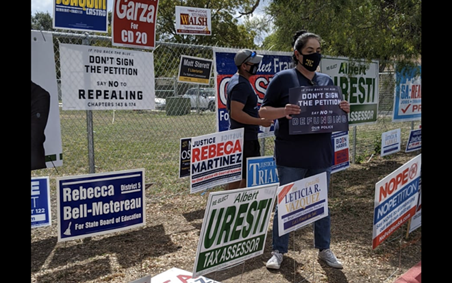 Opponents of the petition drive to put Proposition B on the ballot in 2021 hold signs at a polling site where volunteers collected signatures. - Courtesy Photo / Fix SAPD