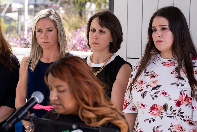 Amanda Zurawski, Molly Duane and Ashley Brandt look on as Samantha Casiano addresses the press following the first day of testimony for Zurawski v. State of Texas in Austin on July 19. - Texas Tribune / Joe Timmerman