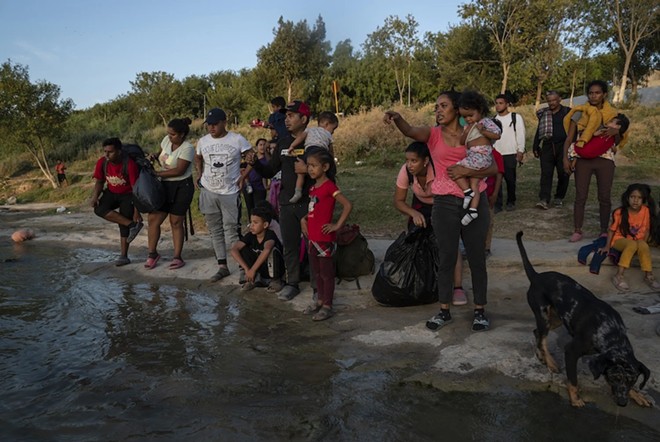 Migrants in in Piedras Negras, Mexico, try to decide where to cross the Rio Grande to turn themselves in to U.S. authorities on July 30. - Texas Tribune / Verónica G. Cárdenas