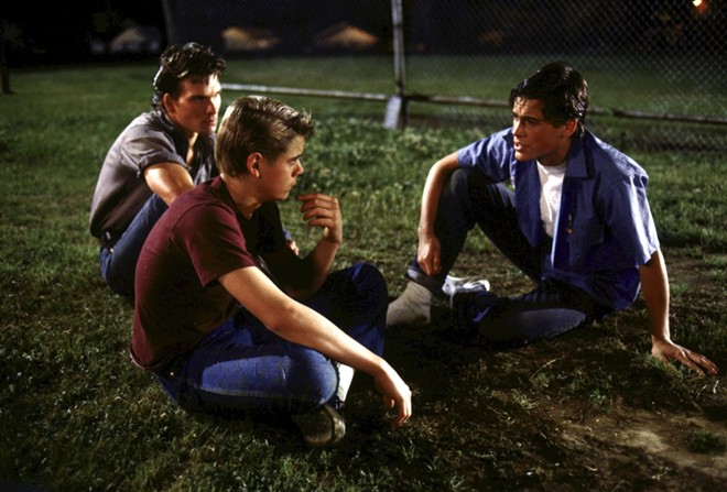 The Outsiders depicts the rivalry between two gangs divided by socioeconomic status — the working-class Greasers and upper-crust Socs. - Warner Bros. Home Entertainment