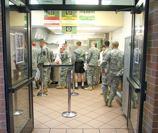 Soldiers stand in line at the Grab and Go section of the Cannon and Castle Grill Dining Facility at Joint Base Lewis-McChord, Wash. - Wikimedia Commons / Pfc. Shaylon Wright