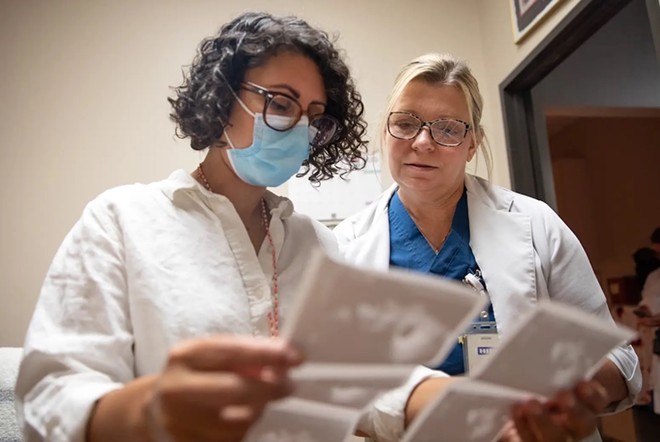 Dr. Amna Dermish, chief operating and medical services officer at Planned Parenthood of Greater Texas, and Melissa Lynn, a nurse practitioner at the Waco clinic, discuss ultrasounds at a Planned Parenthood clinic in Austin on Aug. 8, 2023. - Texas Tribune / Montinique Monroe
