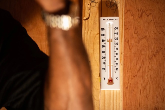 A thermometer is pictured inside a mock prison cell during a “Beat the Heat” awareness event at the Texas Capitol on March 12, 2019. - Texas Tribune / Emree Weaver