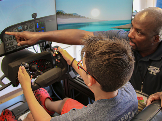 A flight simulator student sits while an instructor tells him what to do. - Courtesy Photo / San Antonio Airport System