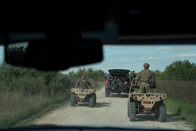 Texas DPS special agents take a group of five undocumented migrants from Honduras that were caught in private property as part of Operation Lone Star in Kinney County near Brackettville, Texas on Nov. 8, 2021. The owner of the property did not sign an affidavit for arrests of undocumented migrants to be taking place at their property so the group will be processed by Border Patrol instead. - Texas Tribune and ProPublica / Verónica G. Cárdenas