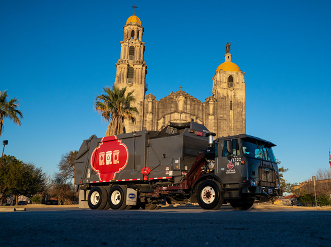 A solid waste management side loader parks in front of one of the San Antonio Missions. - Facebook / City of San Antonio Solid Waste Management