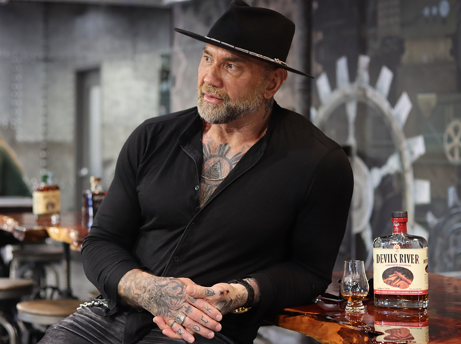 Actor Dave Bautista (left) stands next to a glass of Devils River Whiskey. - Courtesy Photo / Devils River Whiskey
