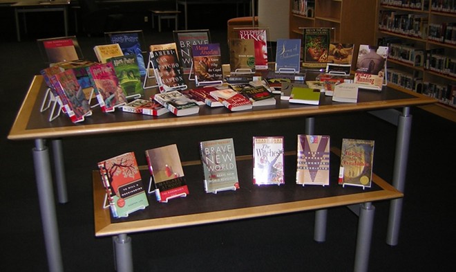 Banned books are arranged on display at a library event. - Wikimedia Commons / college.library