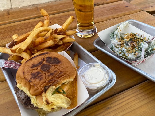 Wurst Behavior offers both burger and hot dog options adorned with its kimchi queso. - Ron Bechtol
