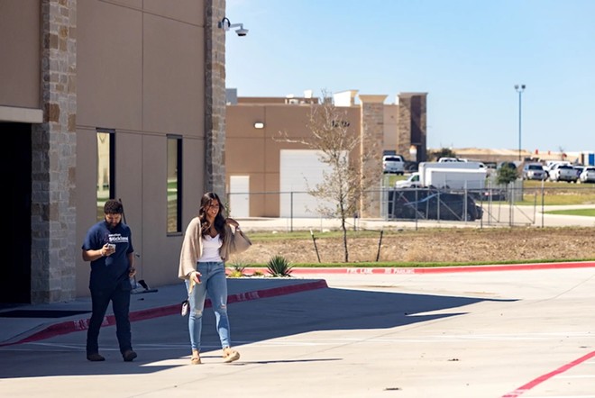 Conservative social media personality Ella Maulding (right) and Fort Worth-based podcaster Kaden Lopez exit the offices of Pale Horse Strategies outside of Fort Worth, Texas on Oct. 6, 2023. - The Texas Tribune