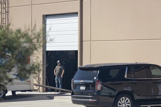 Kyle Rittenhouse is seen helping unload items from a U-Haul at the offices of Pale Horse Strategies outside of Fort Worth on Oct. 6, 2023. - The Texas Tribune