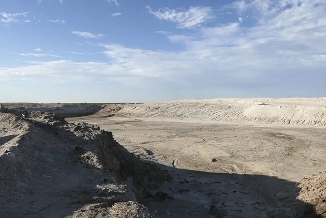 An orphaned well in Crane County began spewing produced water in 2021. The salty water covered an area that required remediation and a large pit was left behind after the salty soil was excavated. Credit: Martha Pskowski - Inside Climate News / Martha Pskowski