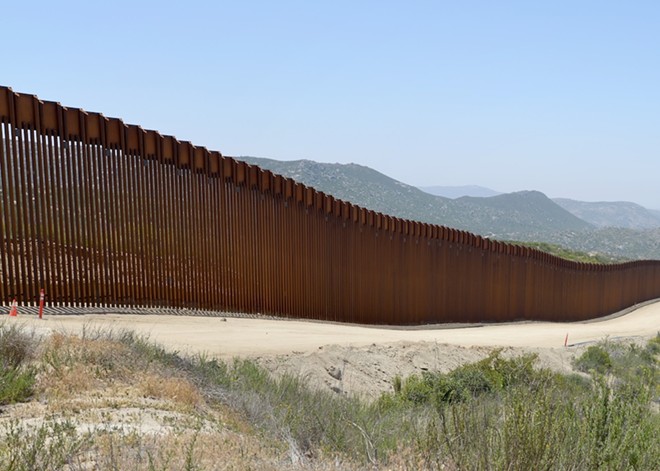 A stretch of wall closes off passage between Mexico and the United States. - Unsplash / Greg Bulla