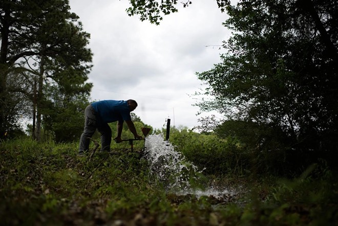 Tom Bailey flushes out a water line in Zavalla on April 10, 2023. Like many small towns, Zavalla has struggled to keep up with repairs to its water infrastructure. - Texas Tribune / Mark Felix